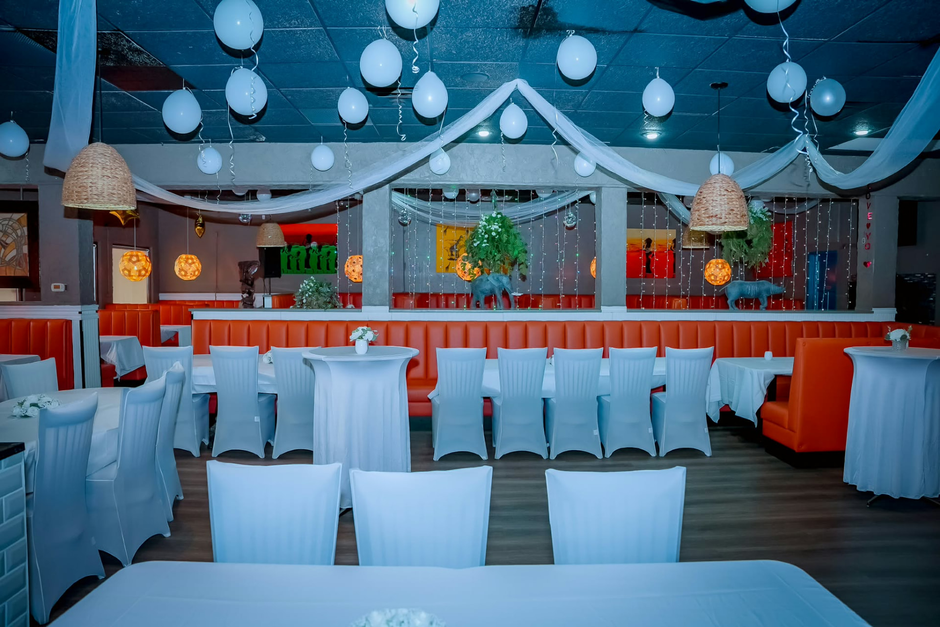 The Kilimanjaro VIP dining room dressed in white linen under warm lanterns