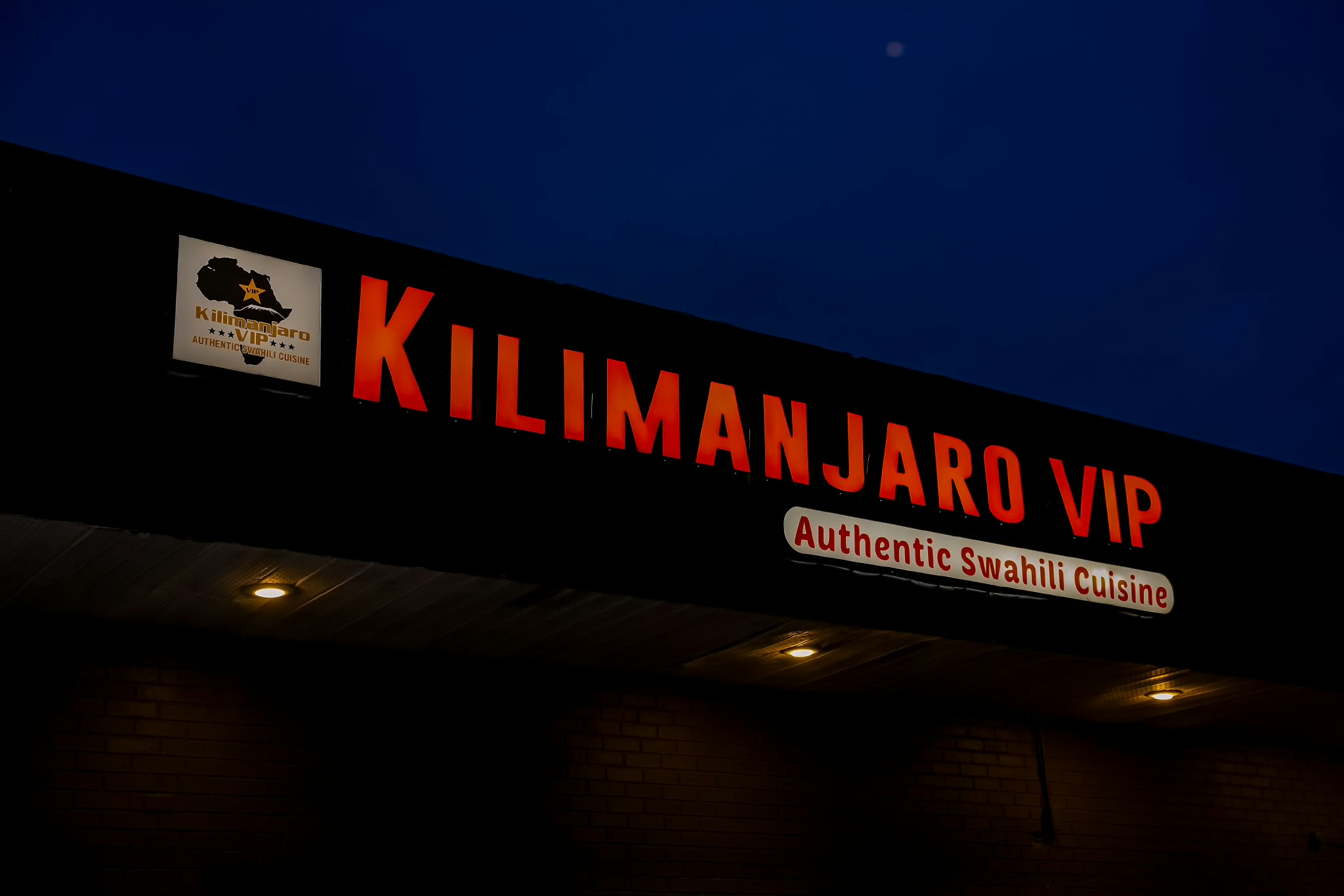 The Kilimanjaro VIP dining room dressed in white linen under warm lanterns